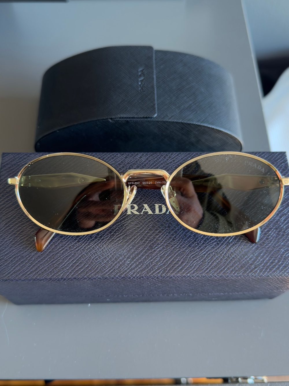 Prada Gold Oval Sunglasses with Dark Lenses